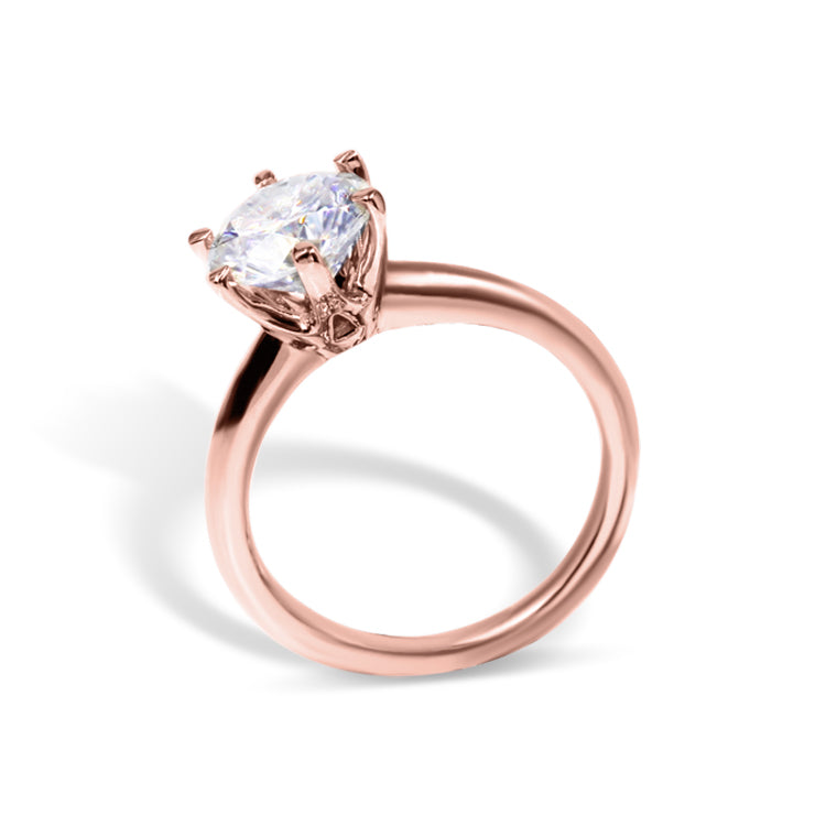 A rose gold solitaire engagement ring with a single central lab diamond or moissanite - side view.