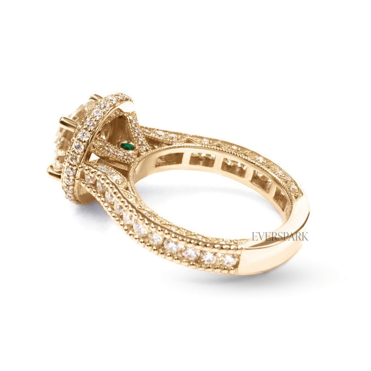 Pia Emerald Gold engagement ring - diagonal view from back - hand-cut Everspark Moissanite, cathedral setting, halo, pave sidestones, milgrain details, peekaboo sidestones, 7mm, 7.5mm, or 8mm round cut center stone, available in 18k White Gold, 18k Yellow Gold, 18k Rose Gold, Platinum 950, Blue Sapphire, Pink Sapphire, Ruby or Emerald sidestones, video: Pia Platinum with Blue Sapphire sidestones, 8mm center stone.