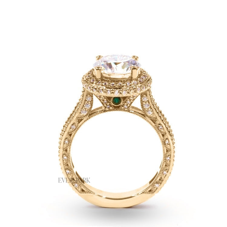 Pia Emerald Gold engagement ring - side profile view - hand-cut Everspark Moissanite, cathedral setting, halo, pave sidestones, milgrain details, peekaboo sidestones, 7mm, 7.5mm, or 8mm round cut center stone, available in 18k White Gold, 18k Yellow Gold, 18k Rose Gold, Platinum 950, Blue Sapphire, Pink Sapphire, Ruby or Emerald sidestones, video: Pia Platinum with Blue Sapphire sidestones, 8mm center stone.