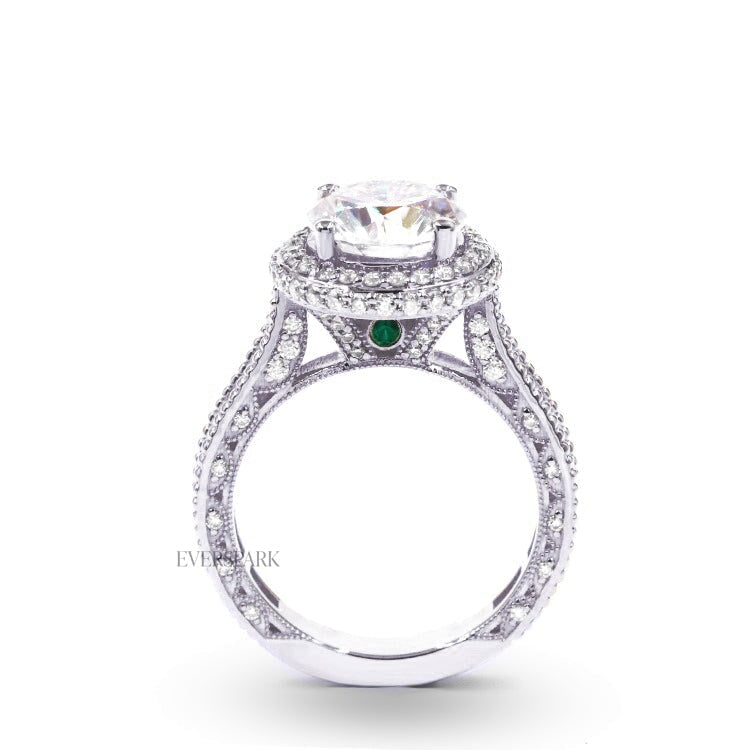 Pia Emerald Platinum engagement ring - side profile view - hand-cut Everspark Moissanite, cathedral setting, halo, pave sidestones, milgrain details, peekaboo sidestones, 7mm, 7.5mm, or 8mm round cut center stone, available in 18k White Gold, 18k Yellow Gold, 18k Rose Gold, Platinum 950, Blue Sapphire, Pink Sapphire, Ruby or Emerald sidestones, video: Pia Platinum with Blue Sapphire sidestones, 8mm center stone.