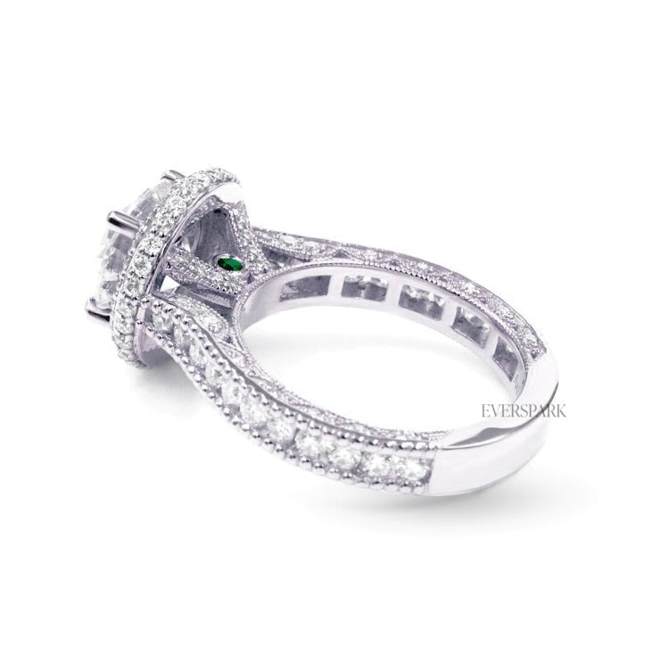 Pia Emerald Platinum engagement ring - diagonal side view - hand-cut Everspark Moissanite, cathedral setting, halo, pave sidestones, milgrain details, peekaboo sidestones, 7mm, 7.5mm, or 8mm round cut center stone, available in 18k White Gold, 18k Yellow Gold, 18k Rose Gold, Platinum 950, Blue Sapphire, Pink Sapphire, Ruby or Emerald sidestones, video: Pia Platinum with Blue Sapphire sidestones, 8mm center stone.
