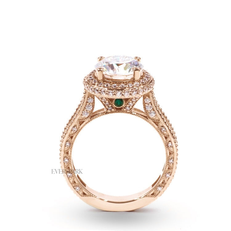 Pia Emerald Rose engagement ring - side profile view - hand-cut Everspark Moissanite, cathedral setting, halo, pave sidestones, milgrain details, peekaboo sidestones, 7mm, 7.5mm, or 8mm round cut center stone, available in 18k White Gold, 18k Yellow Gold, 18k Rose Gold, Platinum 950, Blue Sapphire, Pink Sapphire, Ruby or Emerald sidestones, video: Pia Platinum with Blue Sapphire sidestones, 8mm center stone.